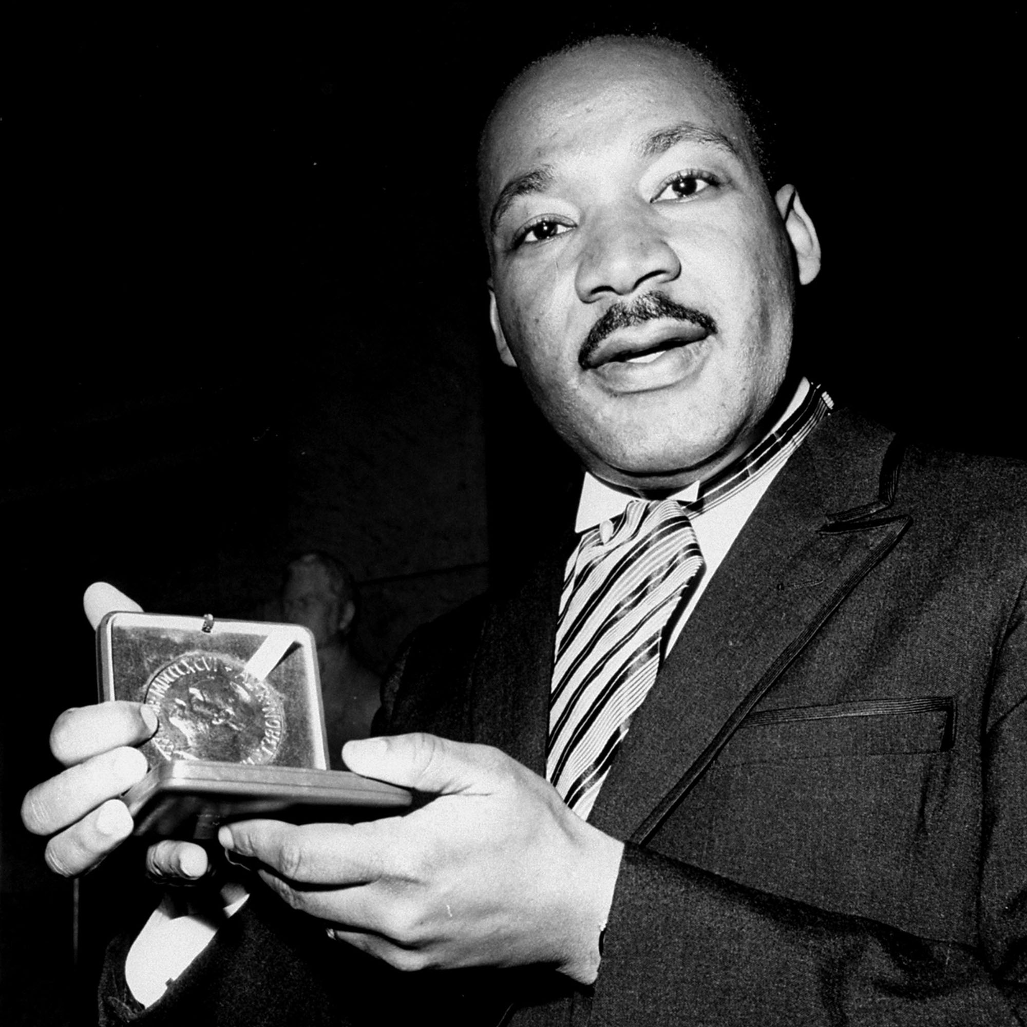 Photo: Dr. Martin Luther King, Jr. displays his 1964 Nobel Peace Prize medal in Oslo, Norway, December 10, 1964. The 35-year-old Dr. King was honored for promoting the principle of non-violence in the civil rights movement. (AP Photo)