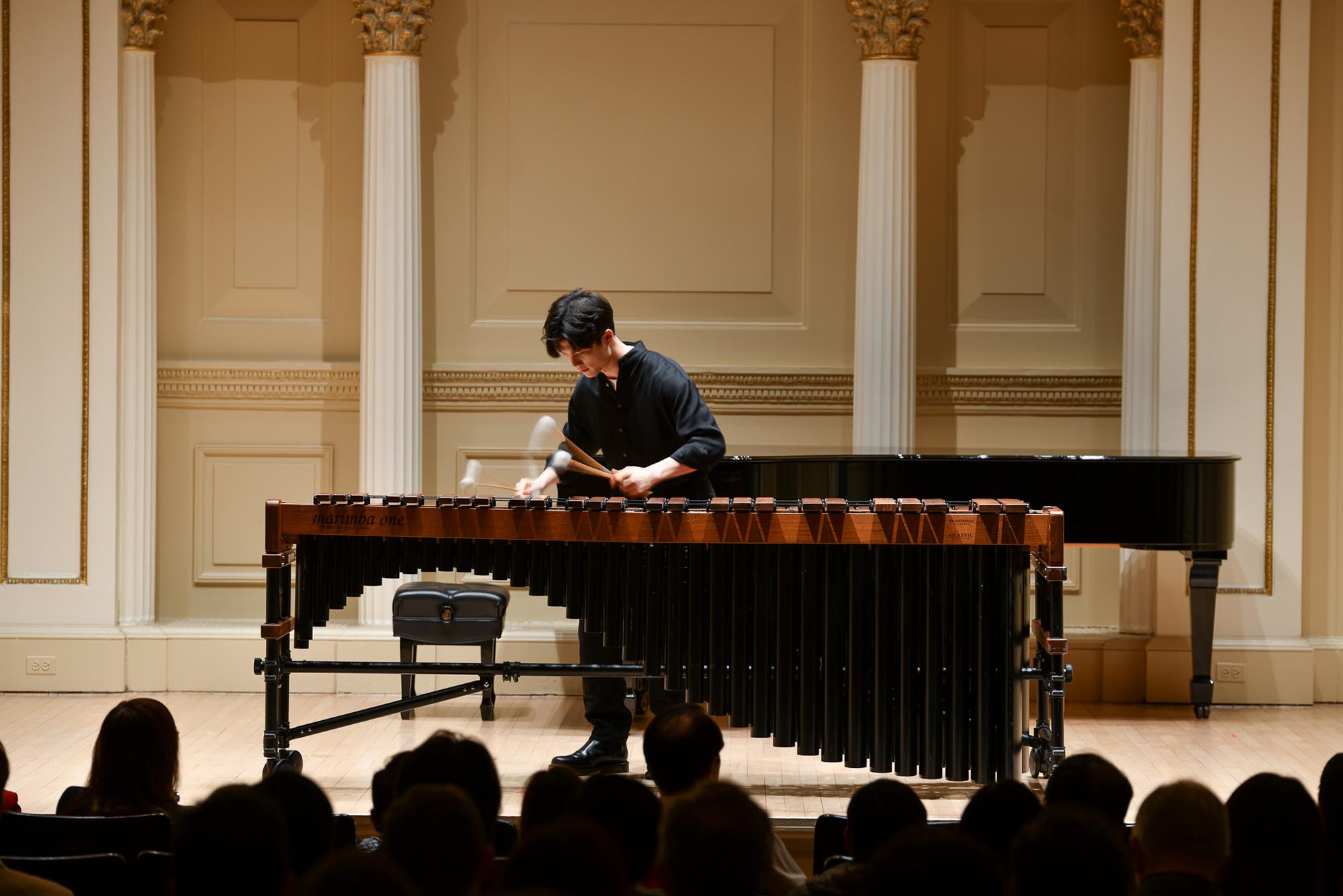 Photo: A young man plays the xylophone at performance at Carnegie Hall. He wears all black.