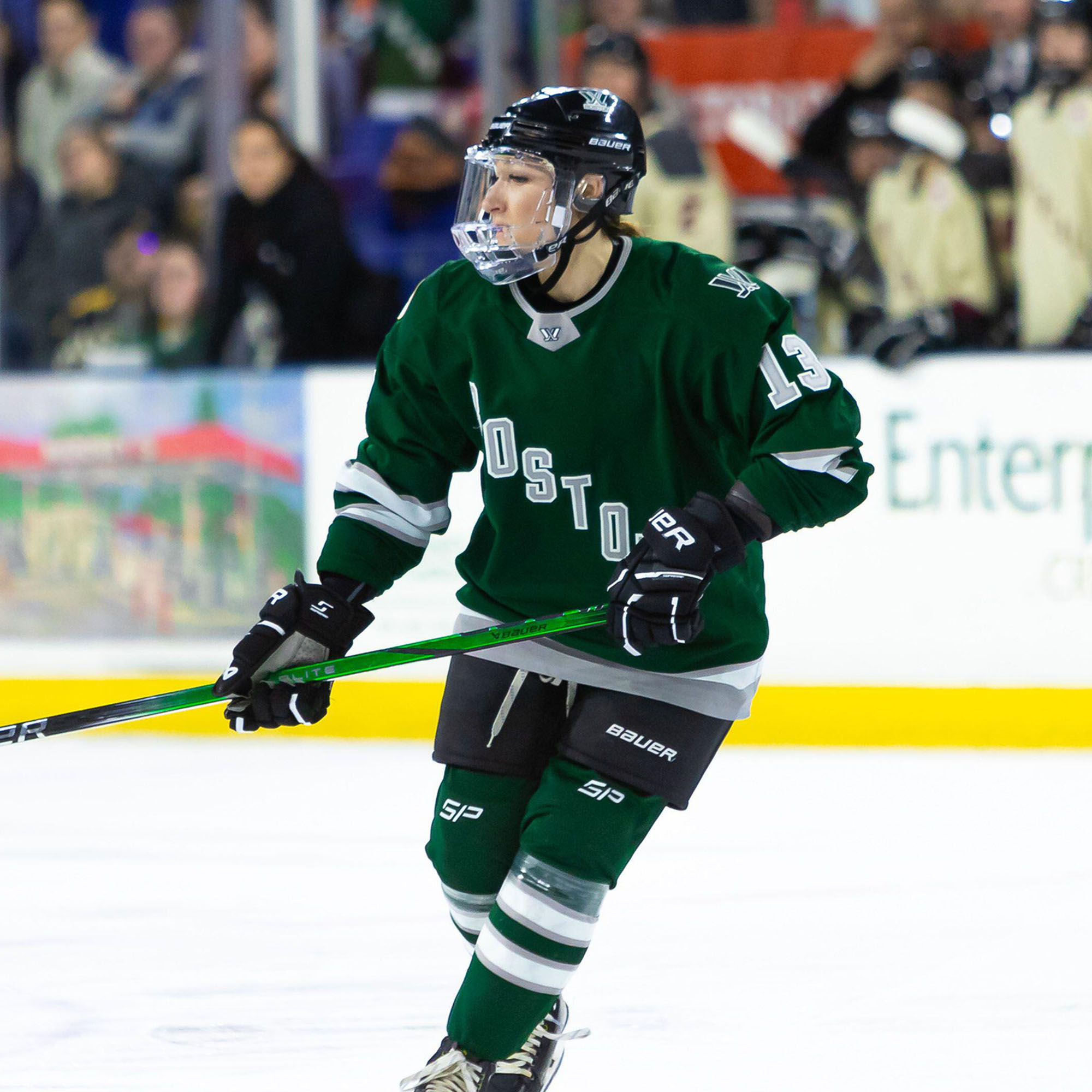Photo: A Professional women's hockey player in a black jersey skates down the rink during a recent game