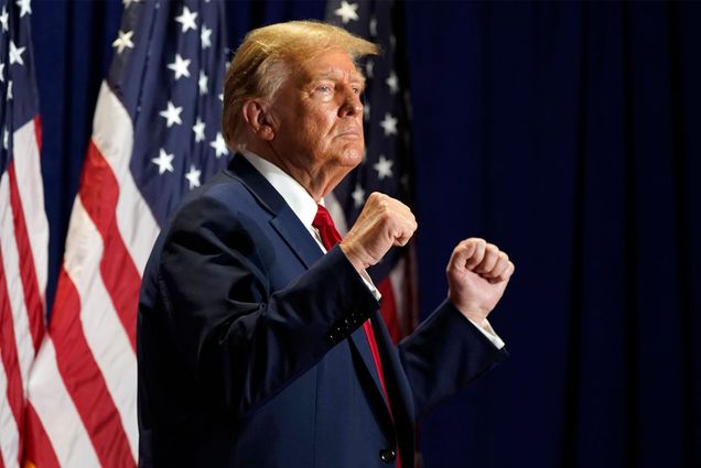 Photo: Donald Trump stands with arms raised at a recent rally