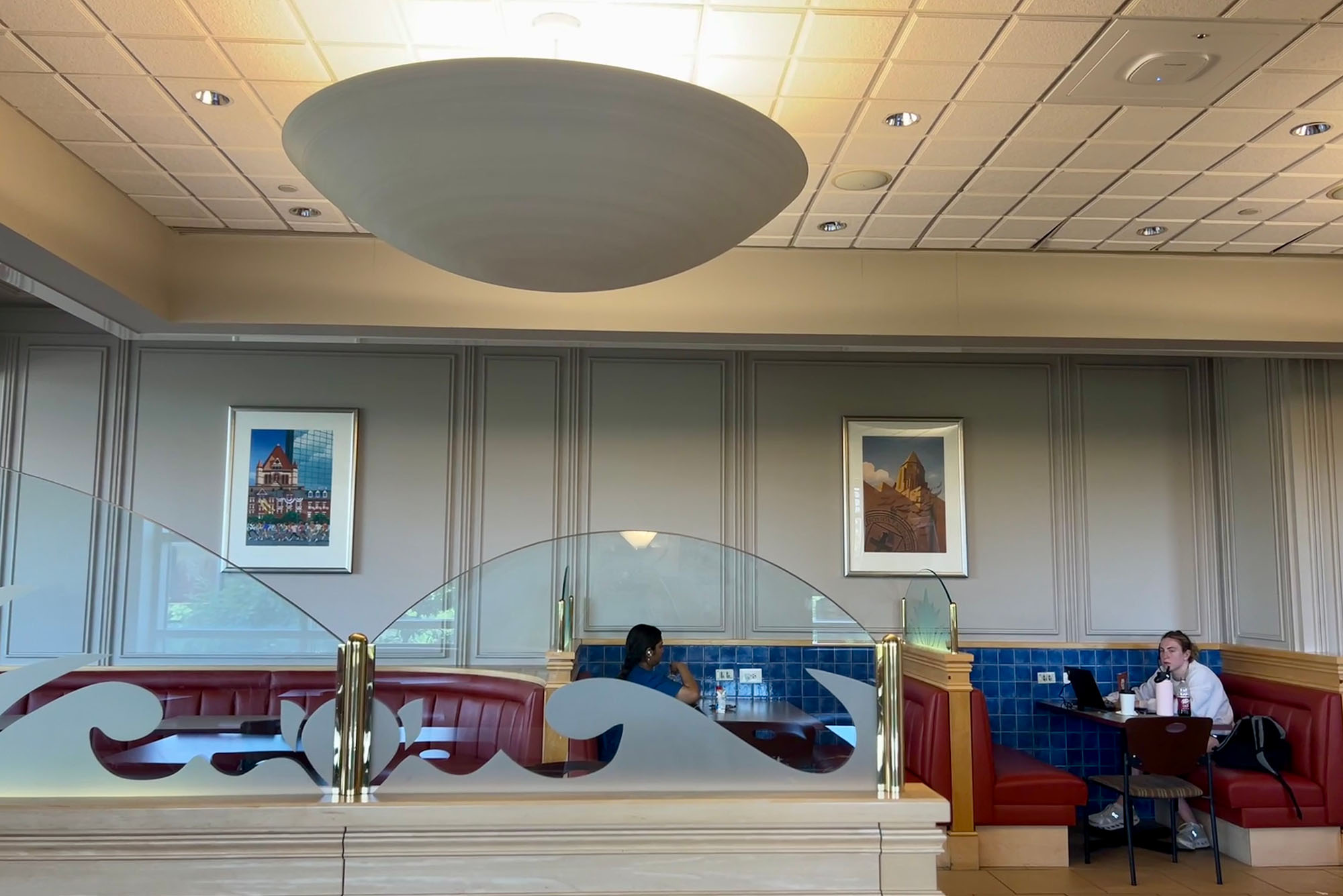 Photo: A picture of a student center cafe where students are working