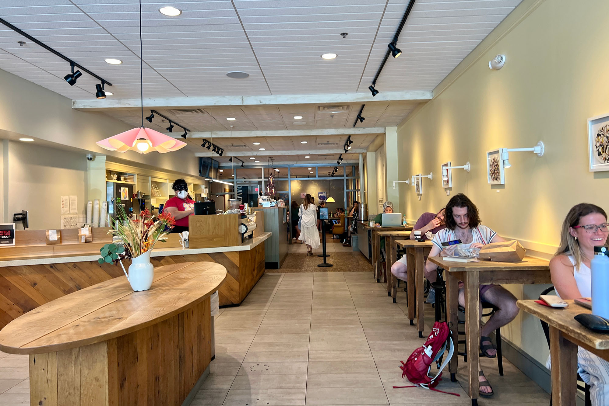 Photo: A picture of the inside of a cafe with people working at the tables