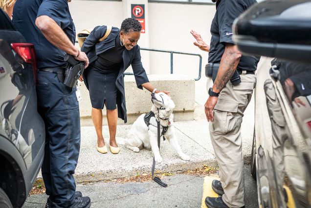 Dr. Melissa Gilliam meets Bean, the BUPD comfort dog, during her first day as the new president on July 1, 2024. Jackie Ricciardi for Boston University