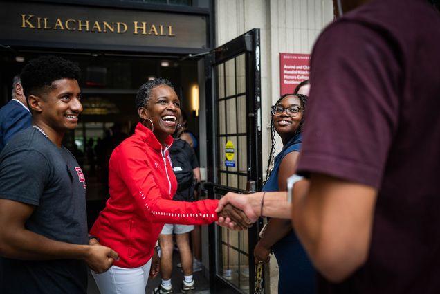 Photo: President Melissa Gilliam greets students and parents as they move into Kilachand Hall