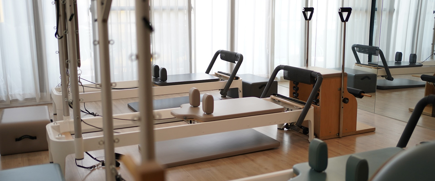 Photo: A pilates studio with reformer machine and various equipment is shown.