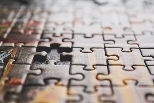 Photo: Zoomed in photo of an incomplete puzzle game. The puzzle is shown with one piece missing.