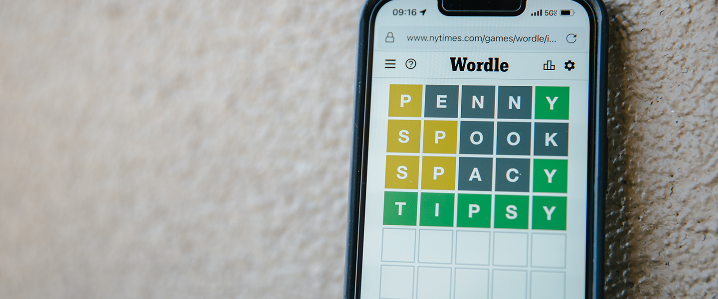 Photo: Overhead shot of a mobile phone with a completed Wordle puzzle shown o the screen.