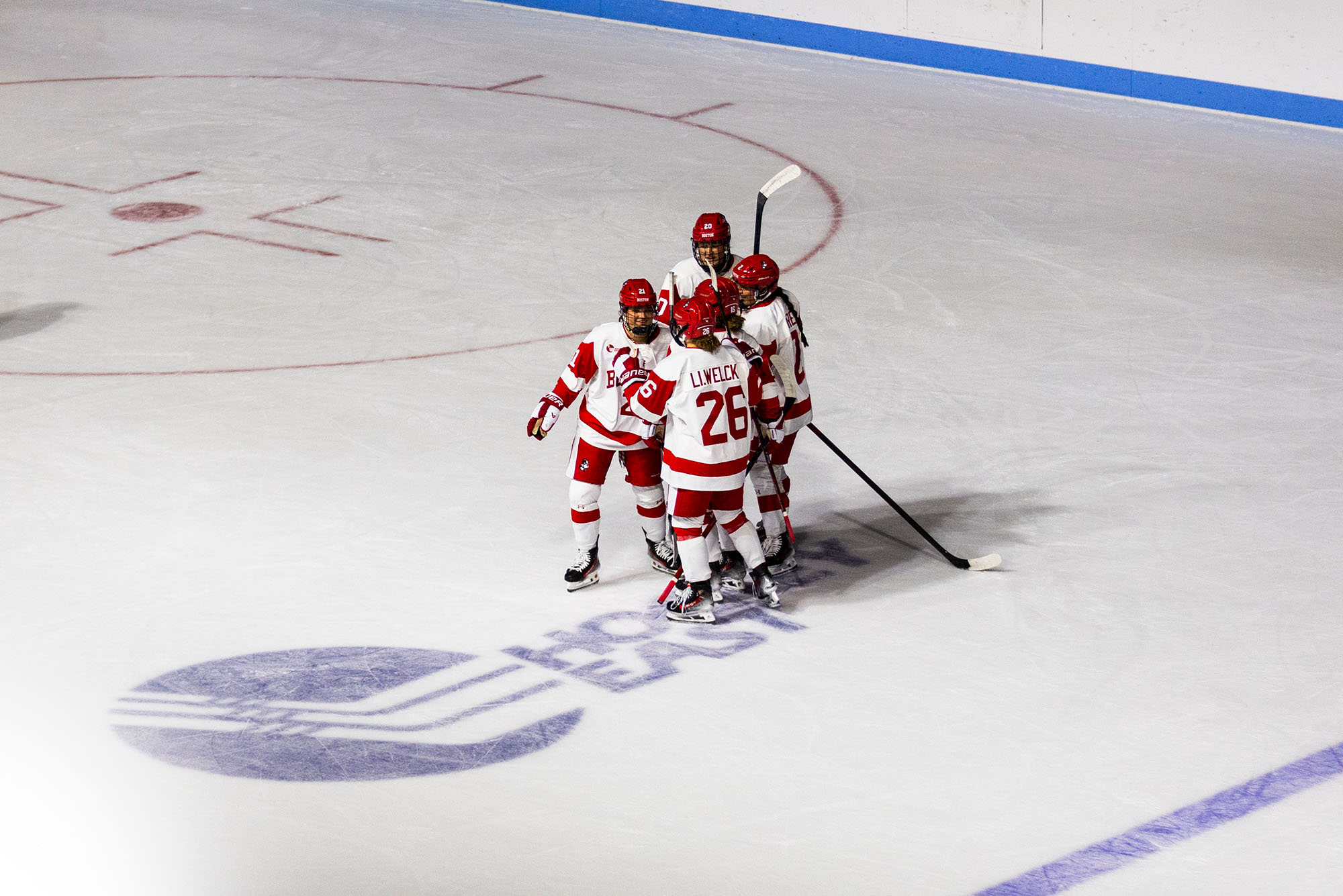 Photo: BU Women's Hockey players celebrating on the ice