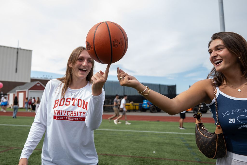 Photo: Students spinning a basketball at BU's SPLASH event