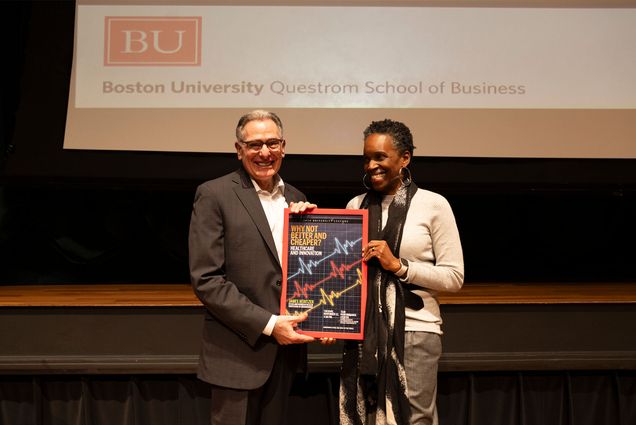 James Rebitzer (left) is presented with a plaque from Boston University President Melissa L. Gilliam shortly before he delivered this year's University Lecture at the Tsai Performance Center, Tuesday, November 12, 2024 titled: "Why Not Better and Cheaper? Healthcare and Innovation." Established in 1950, the University Lecture each year spotlights the outstanding and thought-provoking research and creative work of a BU faculty member to the BU community and general public. Photo by Jake Belcher