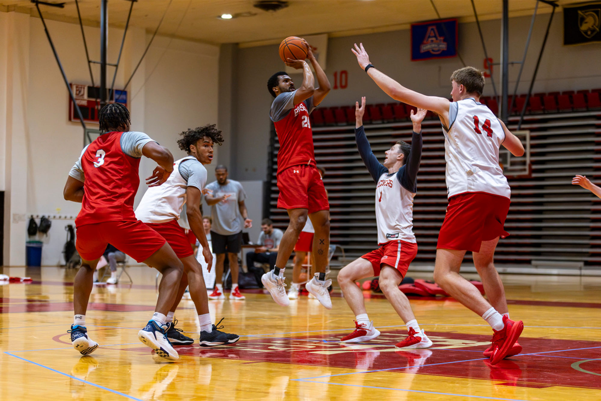 Photo: A basketball player in a red jersey takes a shot in a practice game at Boston University