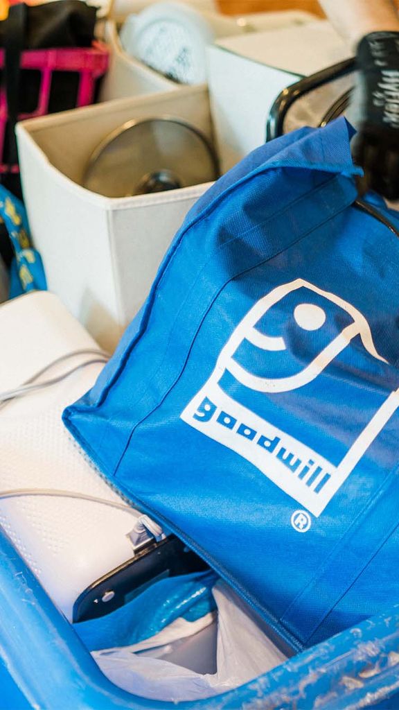 Photo: A tub full of Goodwill bags, with a white and blue logo