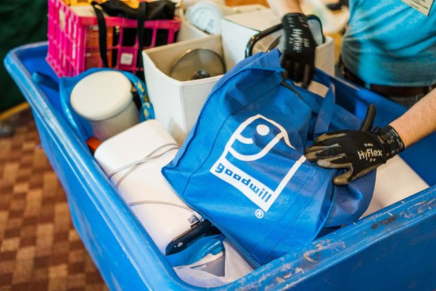 Photo: A tub full of Goodwill bags, with a white and blue logo