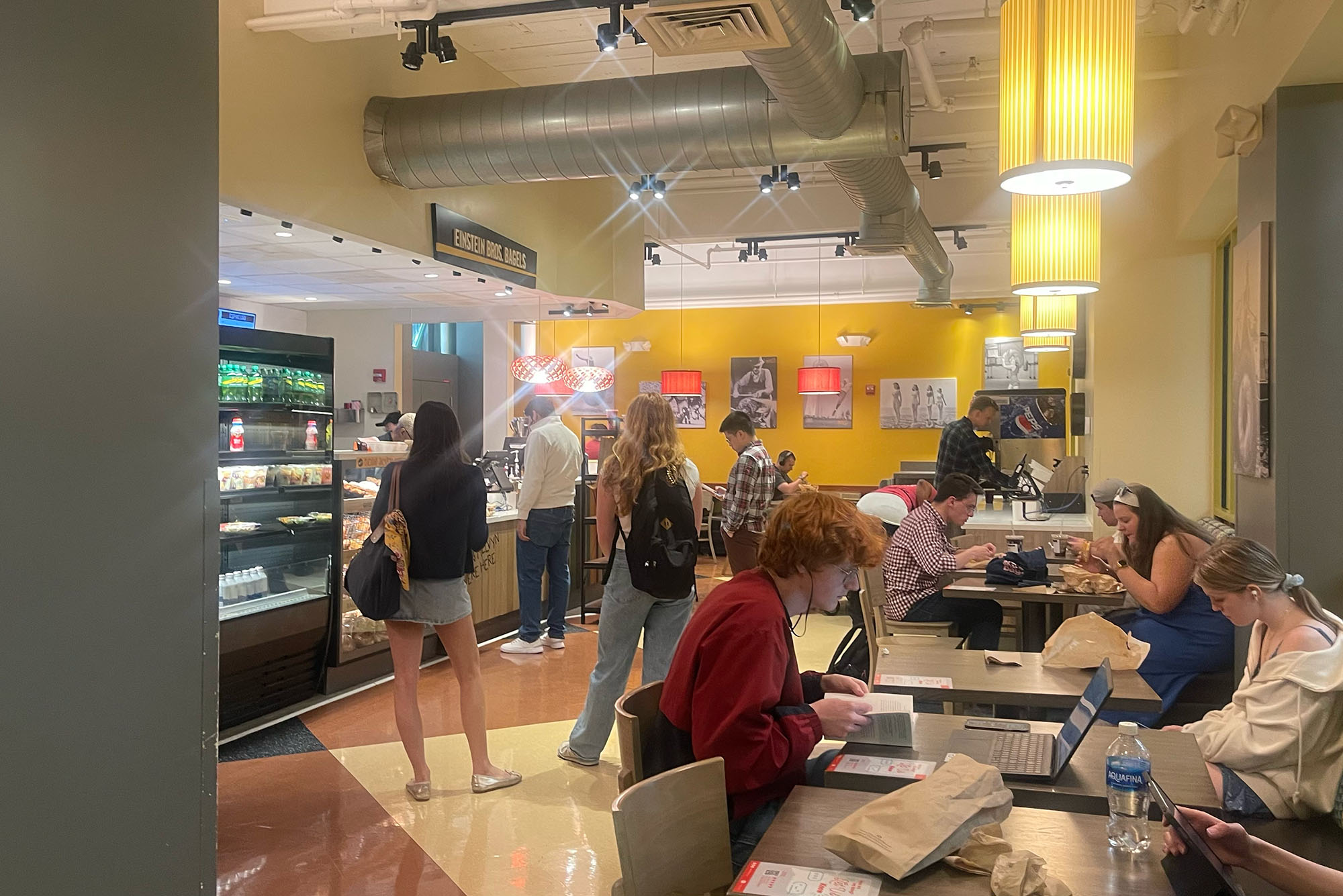 Photo: Einstein Bros. Bagels, a bagel shop with ample seating and students studying