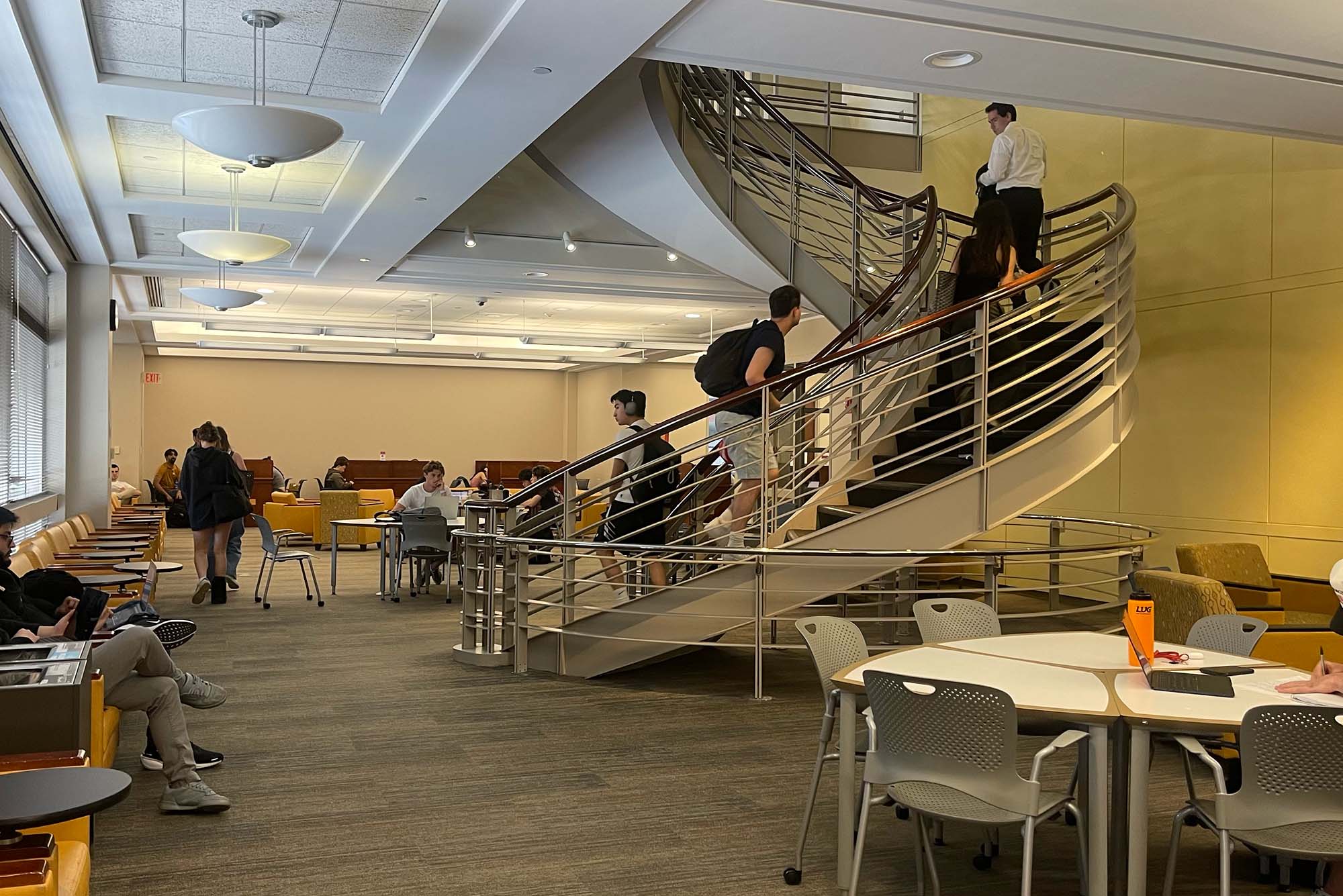 Photo: The Pardee Library at Boston University with a spiral staircase and many students