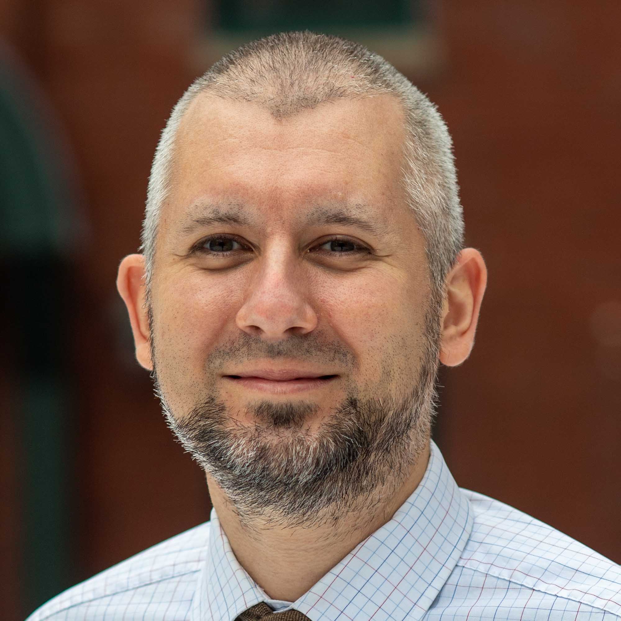 Photo: A portrait of Medicaid Policy Lab co-director Paul Shafer, a white man with short gray hair and beard.
