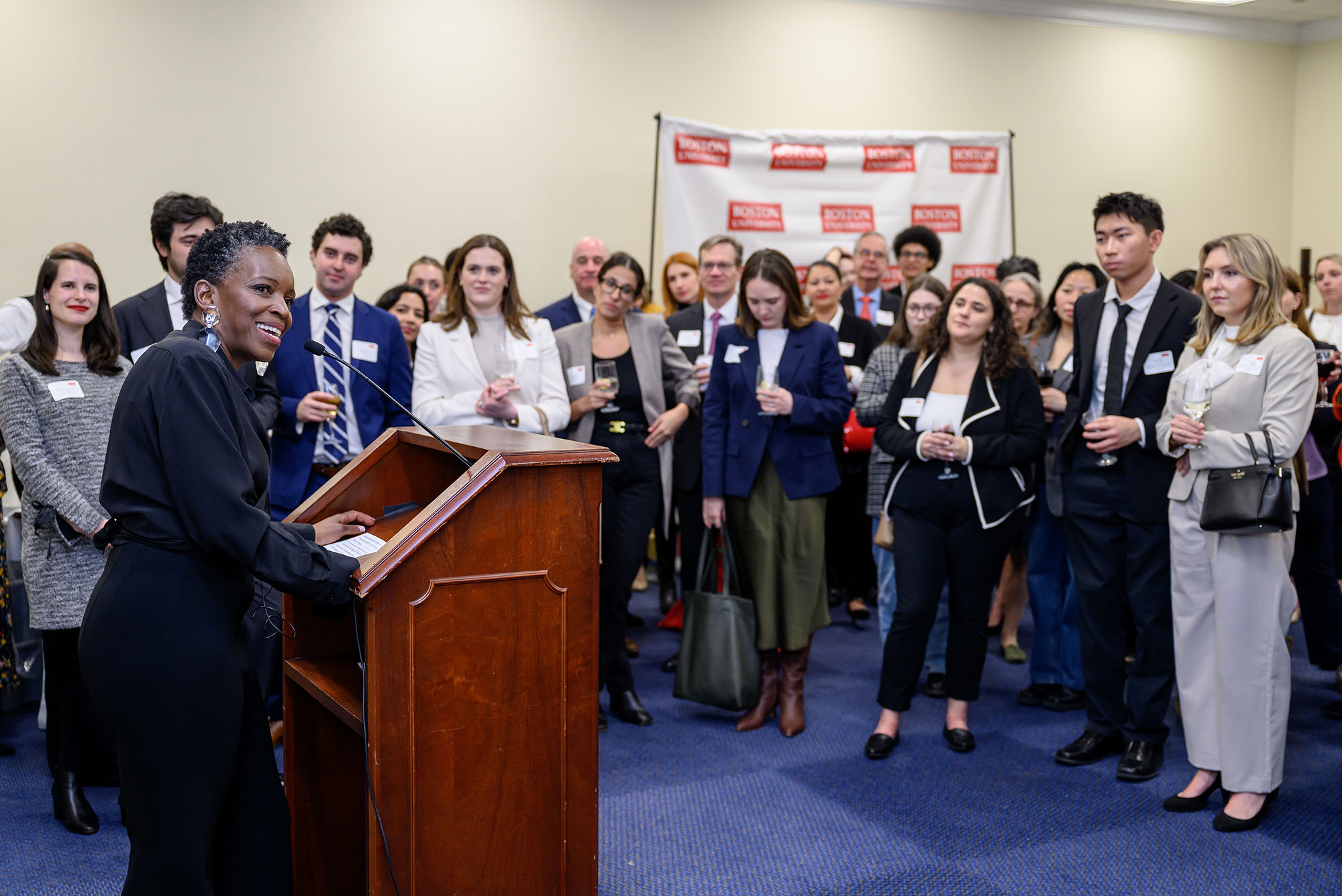 Photo: BU President Melissa Gilliam standing at a podium in front of a crowded room in Washington D.C.