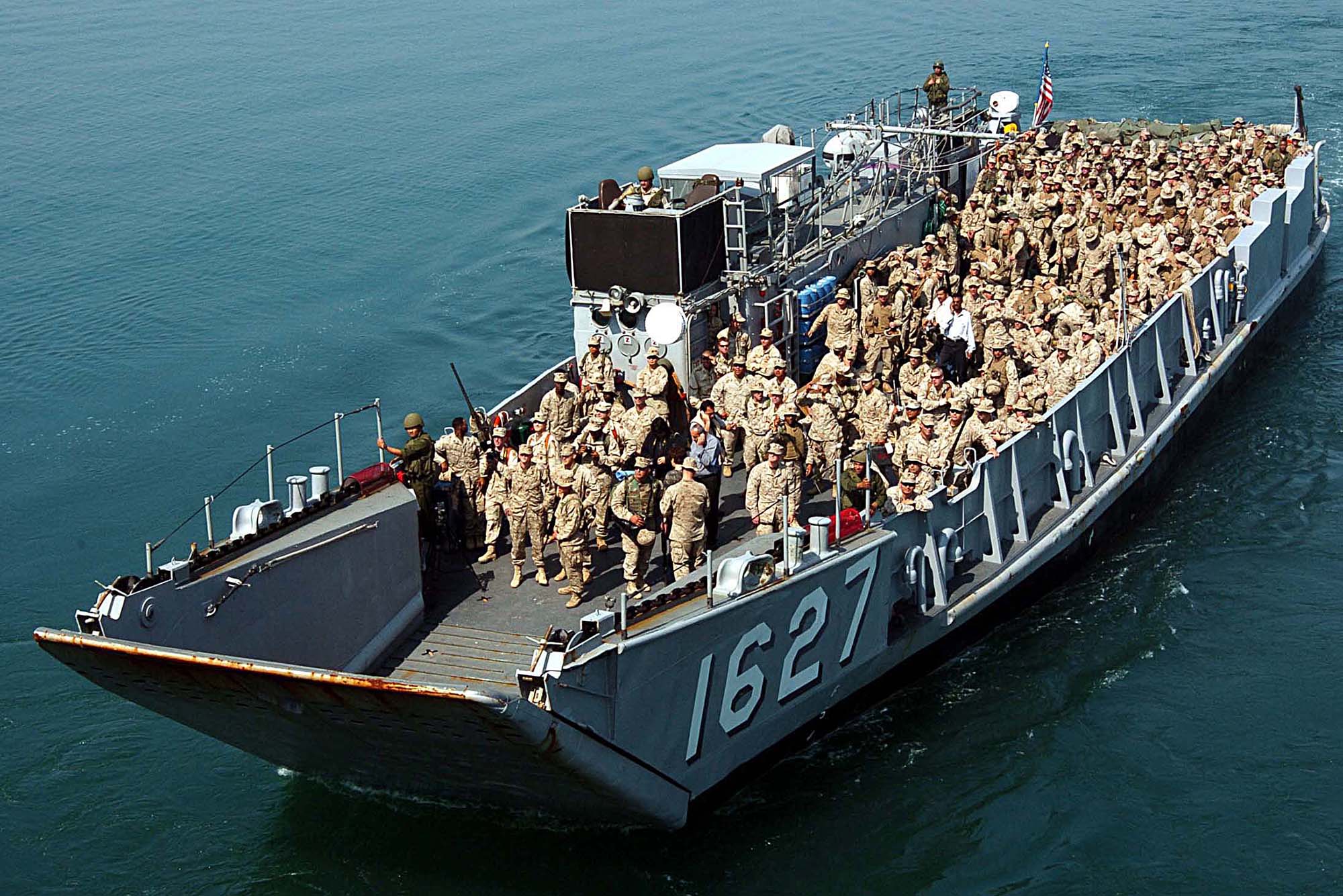 Photo: U.S. Marines and sailors on a ship in the water with "1672" on the side