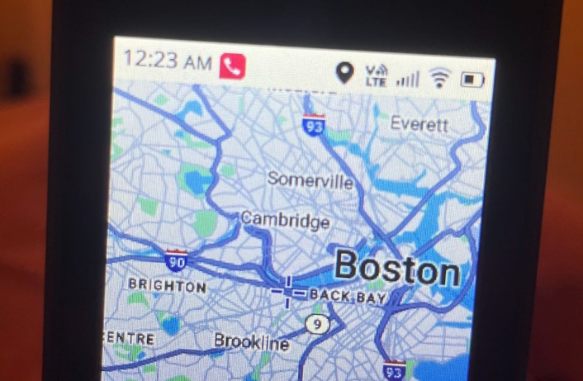 A flip phone with a map of Boston pulled up on it.