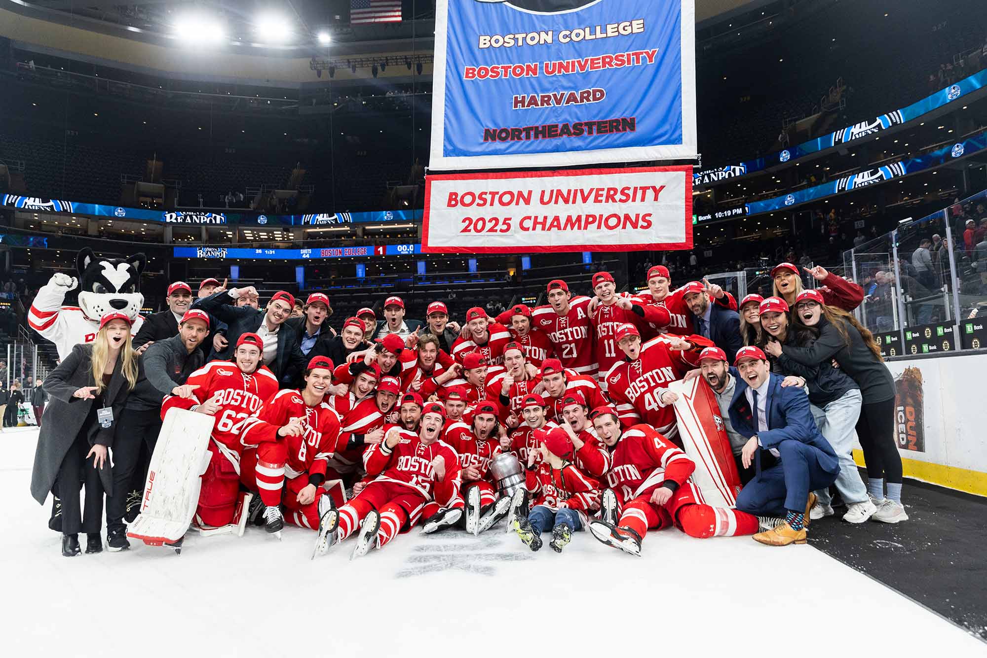 Photo: The BU Terriers Mens Ice Hockey Team, Winners of the BU Beanpot Trophy. The team is seen here posing with the trophy.