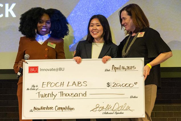 Photo: Three women holding up a check at BU Innovators' Night