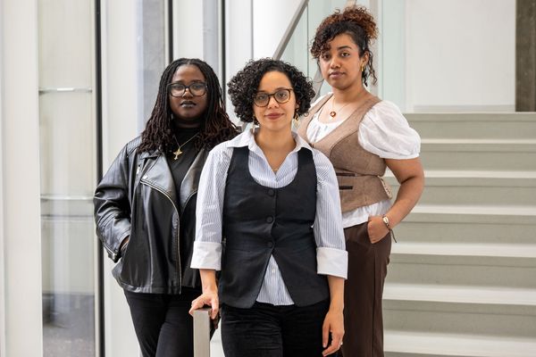 Photo: Three women posing for a photo in front of a set of stairs