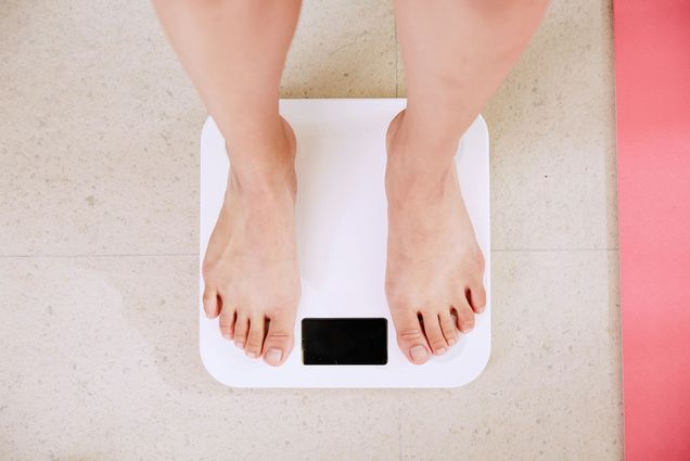 Photo: A person standing on a scale