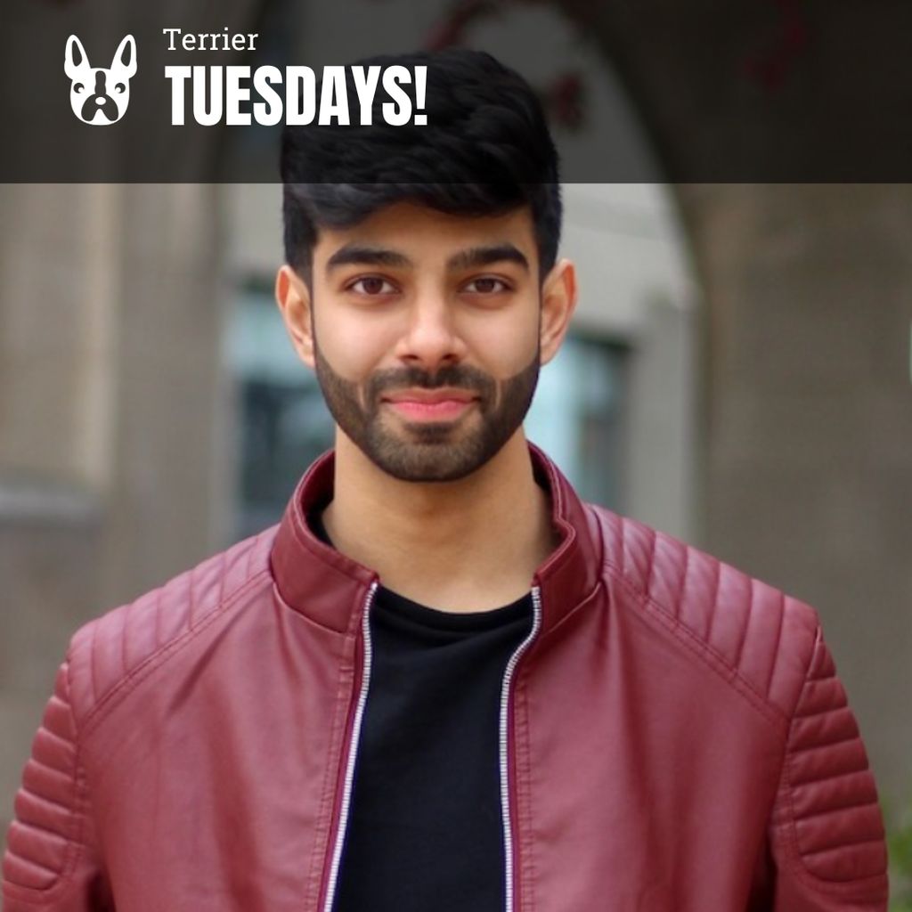 Photo: A headshot-style photo of a man with dark hair and a beard wearing a red leather jacket over a black tshirt. Text overlay reads "Terrier Tuesdays!"