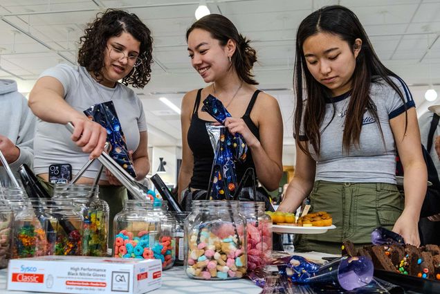 Ligia Sibauste (SAR’27), Ella Sato-Connell (SHA’28) and Ashley Lau (Questrom’28) fill bags with candy and plates with mochi donuts at BU Dining Services’ Slumber Into Summer, hosted on May 1st in the GSU Food Hall. This last day of classes celebration also featured games such as cornhole and Connect 4, a self-care station with face masks and DIY facial scrubs, a movie screening complete with pillow forts, a popcorn machine, and a visit from Bean. Photo by Ajani Hickling (CAS’27).